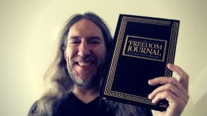 Anthony Metivier holding The Freedom Journal